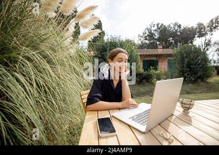 Woman having video call on laptop computer on nature Stock Photo