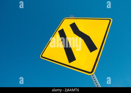 Freeway sign showing merge left as lane ends Stock Photo