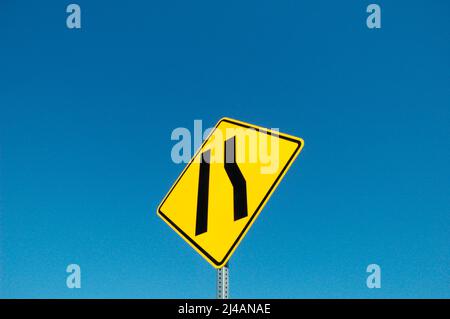 Freeway sign showing merge left as lane ends Stock Photo