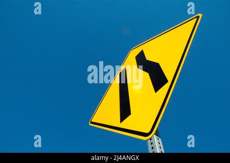 Freeway sign showing merge left as lane ends Stock Photo