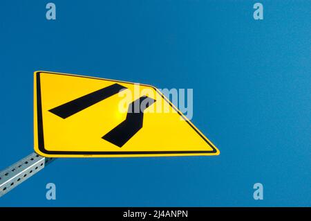 Freeway sign showing merge left as lane ends Stock Photo