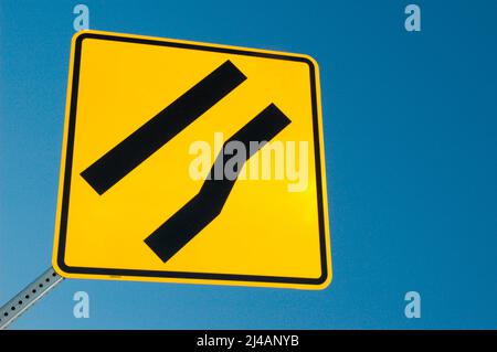 Freeway sign showing merge left as lane ends Stock Photo