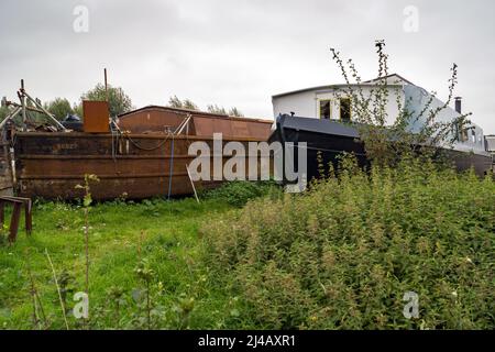 Two canal boats dry docked in a Hertfordshire field, one nearly completed and one ready for work Stock Photo