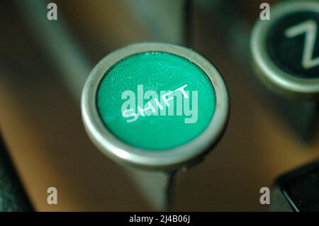 An Old manual typewriter with its working keyes with numbers and letters shift key green Stock Photo