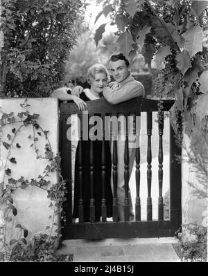 JAMES CAGNEY and his Wife BILLIE / FRANCES CAGNEY in 1933 at the Gate to their Bungalow Home in Hollywood publicity for Warner Bros. Stock Photo