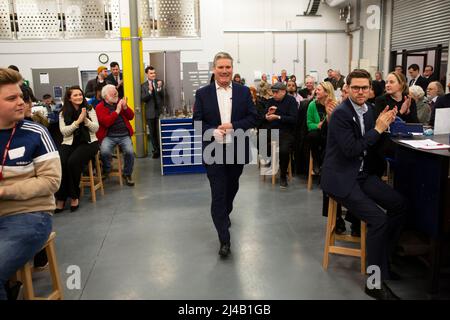 Labour leader Sir Keir Starmer is warmly applauded as he walks into the room before speaking to local people to discuss local and national issues at L Stock Photo