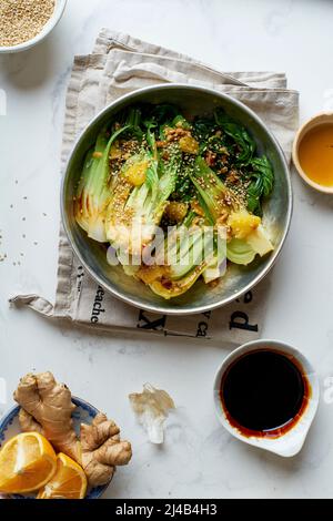 Braised bok choy cabbage with ginger, soy sauce and red orange juice Stock Photo