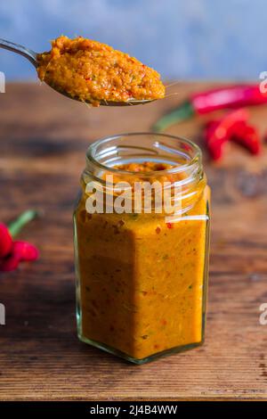 Jar of homemade Thai red curry paste Stock Photo