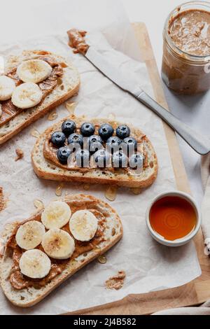 Sourdough toast, served with almond butter, blueberries, banana and a drizzle of honey. Stock Photo