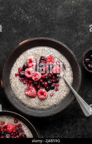 Chia seed pudding, topped with raspberries, blueberries and pomegrante seeds Stock Photo