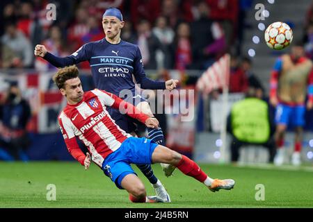 Madrid, Spain. 13th Apr, 2022. Phil Foden of Manchester City and Antoine Griezmann of Atletico de Madrid during the UEFA Champions League match, Quarter Final, Second Leg, between Atletico de Madrid and Manchester City played at Wanda Metropolitano Stadium on April 13, 2022 in Madrid, Spain. (Photo by Ruben Albarran/PRESSINPHOTO) Credit: PRESSINPHOTO SPORTS AGENCY/Alamy Live News