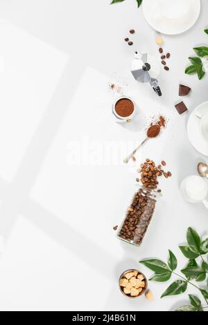 Coffee composition on light grey background, window shadow and green branches, flat lay Stock Photo