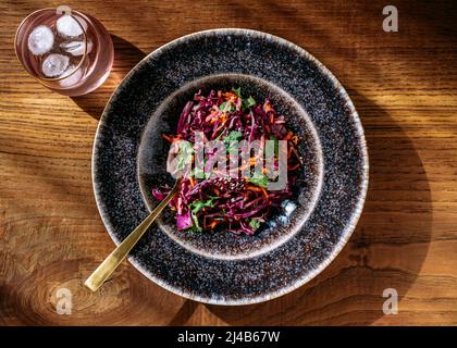 A large red cabbage salad plate, glass, view from above, on wooden background Stock Photo