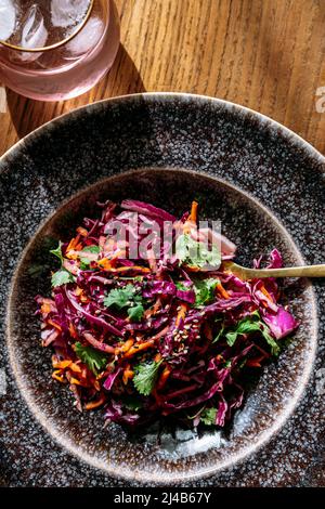 A large red cabbage salad plate, glass, view from above, on wooden background Stock Photo