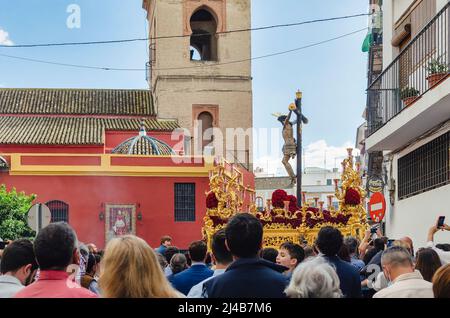 Seville, Spain; April 13, 2022: Procession during the Holy Week in the streets of Seville.  Brotherhood of 'El Buen Fin'.  San Lorenzo Church in the b Stock Photo