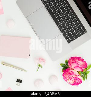 Laptop with roses, pen and diary on white background. Flat lay. Top view Stock Photo