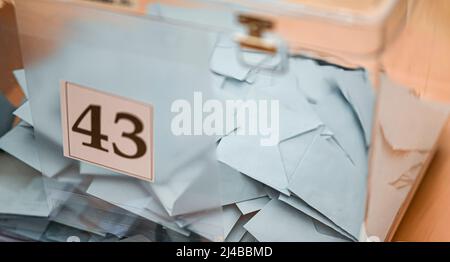 Ballot paper in their envelope placed in the ballot box Stock Photo