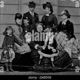 Queen Victoria, with King Edward, Queen Alexandra (at left), King George (between his mother and Queen Victoria), and the Duke of Clarence (standing at left). May 3, 1935. (Photo by Russell & Sons). Stock Photo