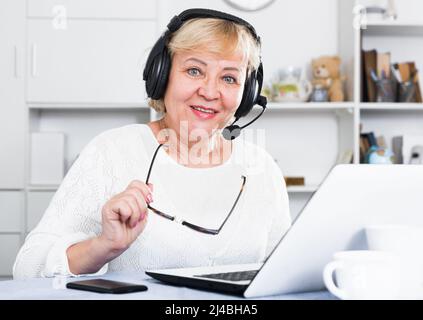 Mature woman communicates via the Internet Stock Photo