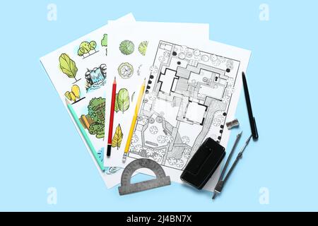 Paper sheets with sketches for landscape design and stationery on color background Stock Photo