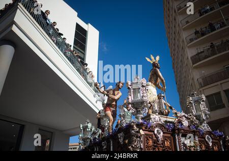 Faithfuls are seen looking at the statue of Christ of 'Fusionadas' brotherhood during the Holy Wednesday, to mark the Holy Week celebrations. After two years without Holy Week due to the coronavirus pandemic, thousands of faithful wait to see the processions bearing the statues of Christ and the Virgin Mary on the streets as part of traditional Holy Week. In Andalusia, the Holy Week celebration congregates thousands of people from all countries, and it's considered one of the most important religious and cultural events of the year. (Photo by Jesus Merida/SOPA Images/Sipa USA) Stock Photo
