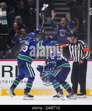 Vancouver Canucks' Quinn Hughes, left, and Jimmy Vesey, right