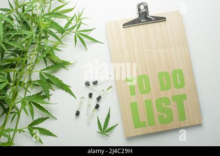 Leaves of hemp with hemp oil on a white background with space for writing Stock Photo