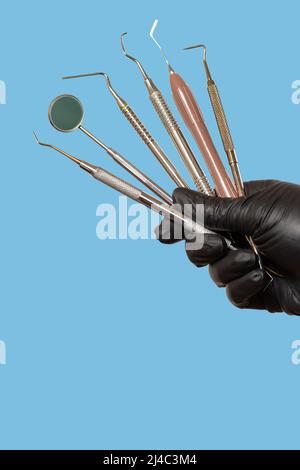 Set of composite filling instruments for dental treatment. Dental mouth mirror, a probe, a plugger and dental restoration instruments. Stock Photo