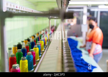 close up of multicolor sewing threads on industrial embroidery machine. select focus of Multicolor sewing threads. tailor sewing concept. Stock Photo