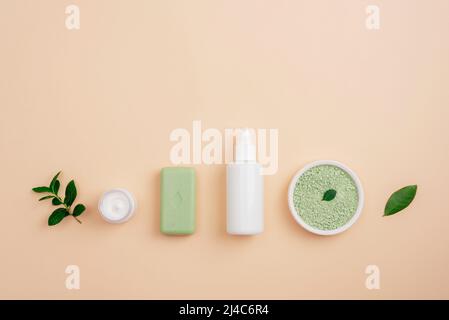 Modern apothecary, natural ingredients. Cosmetic oil, green bath salt, natural soap and face cream, top view, flat lay, copy space. Stock Photo