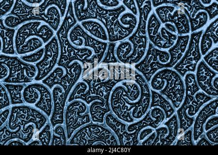 Metallic navy blue background with texture and wavy patterns. Denim backdrop of shiny textile and fabric with curly ornate, macro. Stock Photo