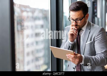 Portrait of frustrated stressed business man working in corporate office Stock Photo