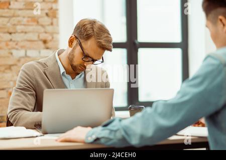 Two young men working together with new project Stock Photo
