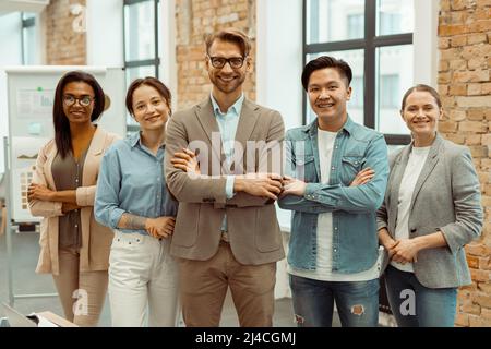 Successful creative business team looking at camera Stock Photo