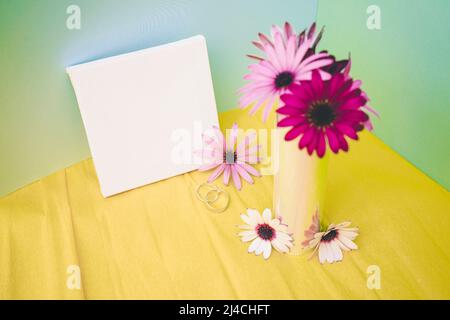 Mockup in fluor tones of a bouquet of flowers and a canvas Stock Photo