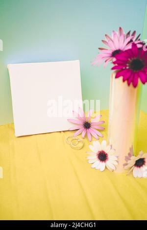 Mockup in fluor tones of a bouquet of flowers and a canvas Stock Photo