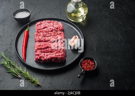 Organic Raw Grass Fed, Ground Beef, on black background with copy space for text Stock Photo