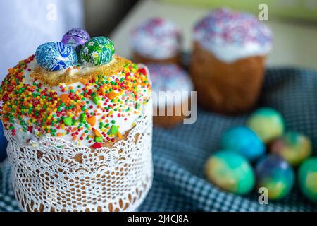 Traditional Easter cake with glace icing and painted easter eggs.Rustic style. Easter arrangement. Stock Photo