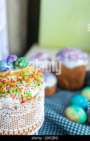 Easter cake with glace icing and colored easter eggs rustic style. Stock Photo