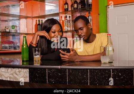 Young couple having a drink together while using the internet Stock Photo
