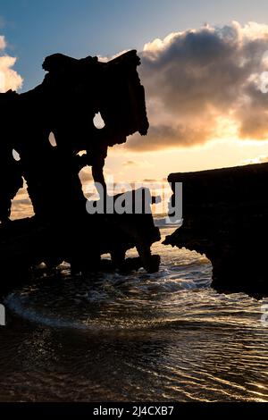 A closeup of a broken section of the starboard side of the Maheno shipwreck at sunrise. Seventy Five Mile Beach, Fraser Island, Queensland, Australia Stock Photo