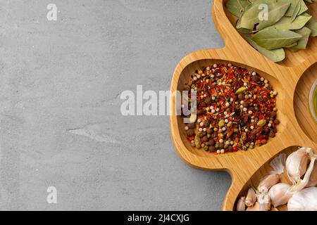 Various spices and herbs on gray background Stock Photo
