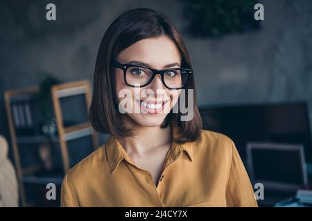 Portrait of attractive cheerful girl skilled qualified executive director wearing formal shirt at workplace workstation indoors Stock Photo