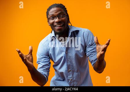 Photo of excited ecstatic overjoyed black man against yellow background Stock Photo