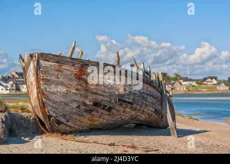 Weathered wreck of wooden fishing boat at Portbail, Cotentin peninsula, Normandy, France Stock Photo