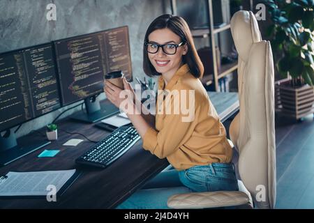 Profile side view portrait of beautiful cheerful smart clever girl geek tech solution developing web project at workplace workstation indoors Stock Photo