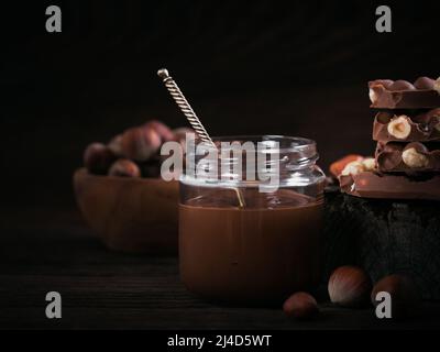 Homemade Chocolate Hazelnut Milk Spread on a dark Background Stock Photo