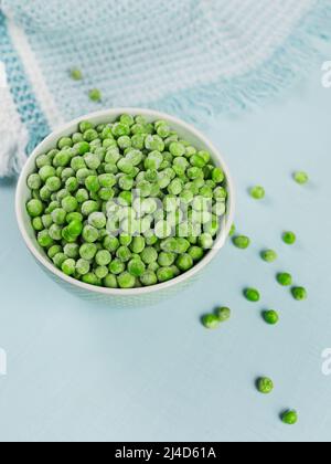 Composition with organic frozen vegetables on a light blue background Stock Photo