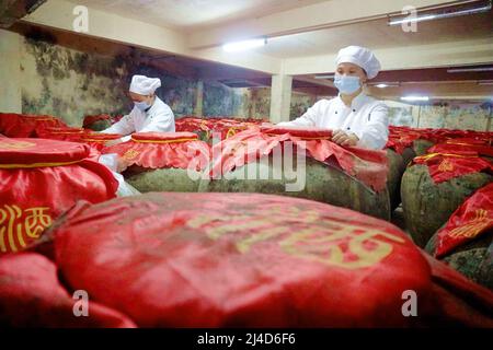 QIANDONGNAN, CHINA - APRIL 14, 2022 - Workers work in a wine cellar in Qiandongnan, Guizhou Province, China, April 14, 2022. Stock Photo