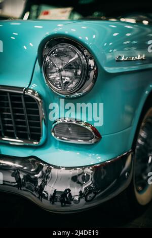 Izmir, Turkey - December 4, 2021: Close up shot of a blue colored Chevrolet brand classic cars headlight at the exhibition of classic cars Izmir fair. Stock Photo